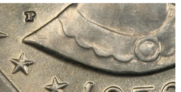 Location of the mint Mark on the Susan B Anthony dollar coin. 